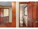 Cozy powder room with a toilet, unique wallpaper, and traditional finishes, creating a functional space at 1800 East Gate Dr, Smoke Rise, GA 30087