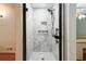 Modern shower featuring marble tile, a sleek glass door, and updated fixtures, enhancing the bathroom's appeal at 1800 East Gate Dr, Smoke Rise, GA 30087