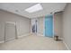 Tiled basement features a blue door and a neutral color scheme, providing a versatile space for various uses at 4819 Elam Rd, Stone Mountain, GA 30083