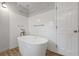 Modern bathroom featuring a standalone tub, updated fixtures, and tiled shower area at 4819 Elam Rd, Stone Mountain, GA 30083