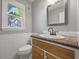Bathroom with a modern vanity with granite countertop, sleek fixtures and a large mirror at 4819 Elam Rd, Stone Mountain, GA 30083