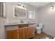 Modern bathroom with wood-look tile flooring, custom vanity, and neutral wall colors at 4819 Elam Rd, Stone Mountain, GA 30083