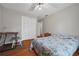 Cozy bedroom with hardwood floors, ceiling fan, and a closet at 4819 Elam Rd, Stone Mountain, GA 30083