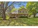 Charming two-story home with a brick foundation, covered porch, and a lush, green lawn at 4819 Elam Rd, Stone Mountain, GA 30083