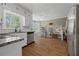 Modern kitchen with stainless steel appliances, granite countertops, and wood-look tile flooring at 4819 Elam Rd, Stone Mountain, GA 30083