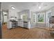 Bright kitchen featuring white cabinets, stainless steel appliances, and a cozy breakfast nook at 4819 Elam Rd, Stone Mountain, GA 30083