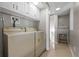 Functional laundry room with washer, dryer, utility sink, and white cabinets at 4819 Elam Rd, Stone Mountain, GA 30083