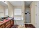 Bathroom featuring a double vanity, soaking tub, a standing shower, and natural light at 510 Ashland Manor Dr, Lawrenceville, GA 30045