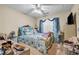 Cozy bedroom with a ceiling fan, blue floral bedding, and natural light from the window at 510 Ashland Manor Dr, Lawrenceville, GA 30045
