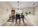 Dining room with wood table, black chairs, decorative chandelier, and plant accents at 510 Ashland Manor Dr, Lawrenceville, GA 30045