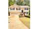 Charming two-story home featuring a two-car garage and inviting front porch, set amidst lush greenery at 510 Ashland Manor Dr, Lawrenceville, GA 30045