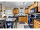 Kitchen featuring wooden cabinets, granite countertops, and updated black appliances at 510 Ashland Manor Dr, Lawrenceville, GA 30045