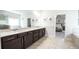 A bathroom with double sinks, dark cabinets, and a large mirror offers an elegant and functional space at 715 Laura Jean Court, Buford, GA 30518