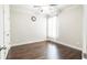 A bedroom with beautiful wood flooring and a window to let in natural light at 715 Laura Jean Court, Buford, GA 30518