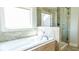 Bright bathroom with a soaking tub and glass-enclosed shower at 715 Laura Jean Ct, Buford, GA 30518