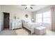 Comfortable bedroom with white wood bedframe, accent pillows and closet at 715 Laura Jean Ct, Buford, GA 30518
