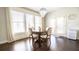 Cozy dining area with chandelier, natural light, and hardwood floors at 715 Laura Jean Ct, Buford, GA 30518
