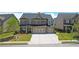 Charming two-story home with well-maintained lawn, mature tree, and a spacious driveway at 715 Laura Jean Ct, Buford, GA 30518