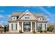 Charming home exterior with craftsman style architecture and manicured landscaping at 715 Laura Jean Ct, Buford, GA 30518