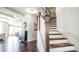 Bright foyer with hardwood floors, staircase with runner, chandelier, and elegant furnishings at 715 Laura Jean Ct, Buford, GA 30518