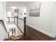 Upstairs hallway features hardwood floors, white trim, and a view to the lower level at 715 Laura Jean Ct, Buford, GA 30518
