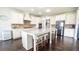 Modern kitchen with white cabinets, granite countertops, stainless steel appliances, and island seating at 715 Laura Jean Ct, Buford, GA 30518