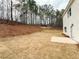 Large backyard showcasing freshly laid sod and bordering scenic, wooded views at 120 Cedar Cliff Ct, Temple, GA 30179