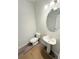 Powder room featuring a pedestal sink and a modern lighting fixture at 120 Cedar Cliff Ct, Temple, GA 30179