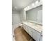 This is a bright bathroom with double sinks and vanity with granite countertop at 120 Cedar Cliff Ct, Temple, GA 30179