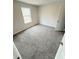 Cozy bedroom with a sunlit window and neutral carpeting, ideal for relaxation at 120 Cedar Cliff Ct, Temple, GA 30179