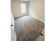 A carpeted bedroom featuring neutral walls and a window for natural light at 120 Cedar Cliff Ct, Temple, GA 30179