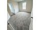 A carpeted bedroom featuring neutral walls, a window and white doors at 120 Cedar Cliff Ct, Temple, GA 30179