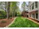 The backyard features lush greenery and mature trees, alongside a spacious lawn and deck at 325 N Saint Phillip Ln, Alpharetta, GA 30022