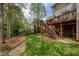Backyard features a well-maintained lawn, patio, and deck with wooded surroundings at 325 N Saint Phillip Ln, Alpharetta, GA 30022