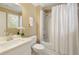 Bathroom with white vanity, shower with curtain, and tile flooring, a clean and modern space at 325 N Saint Phillip Ln, Alpharetta, GA 30022