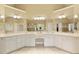Large bathroom vanity with dual sinks, white cabinets, and a large framed mirror at 325 N Saint Phillip Ln, Alpharetta, GA 30022