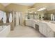 Spacious bathroom featuring a soaking tub, glass shower, and dual sink vanity with white cabinets at 325 N Saint Phillip Ln, Alpharetta, GA 30022