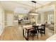 Dining room area with a modern chandelier that opens to the living room space at 325 N Saint Phillip Ln, Alpharetta, GA 30022