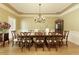 Formal dining room with hardwood floors, elegant chandelier, and ample seating for gatherings at 325 N Saint Phillip Ln, Alpharetta, GA 30022