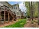 Back exterior with a large deck, stone pathway, and well-kept lawn at 325 N Saint Phillip Ln, Alpharetta, GA 30022