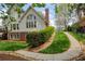 Exterior view of a house with manicured lawn, rock-lined landscaping, and partial hedge at 325 N Saint Phillip Ln, Alpharetta, GA 30022