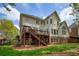 Back exterior view of a home with a deck, patio and nicely landscaped backyard at 325 N Saint Phillip Ln, Alpharetta, GA 30022