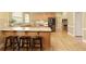 Eat-in kitchen with granite countertops, stainless steel appliances, and breakfast bar at 325 N Saint Phillip Ln, Alpharetta, GA 30022
