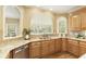 Well-lit kitchen with granite counters, stainless steel dishwasher, and natural light at 325 N Saint Phillip Ln, Alpharetta, GA 30022