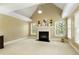 Bright living room showcases a fireplace, multiple windows, a tray ceiling, and cozy seating around the hearth at 325 N Saint Phillip Ln, Alpharetta, GA 30022