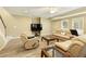 Spacious living room with plenty of natural light and comfortable leather seating at 325 N Saint Phillip Ln, Alpharetta, GA 30022