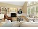 Living room includes a fireplace, built-in shelving, and lots of natural light at 325 N Saint Phillip Ln, Alpharetta, GA 30022