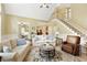 Comfortable living room showcases two sofas, a leather chair, staircase, and an elaborate area rug over hardwood floors at 325 N Saint Phillip Ln, Alpharetta, GA 30022