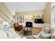 Cozy living room with a fireplace, built-in shelves and views to the backyard at 325 N Saint Phillip Ln, Alpharetta, GA 30022