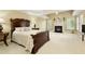 Spacious main bedroom with a fireplace, tray ceiling, and large windows, creating a serene retreat at 325 N Saint Phillip Ln, Alpharetta, GA 30022